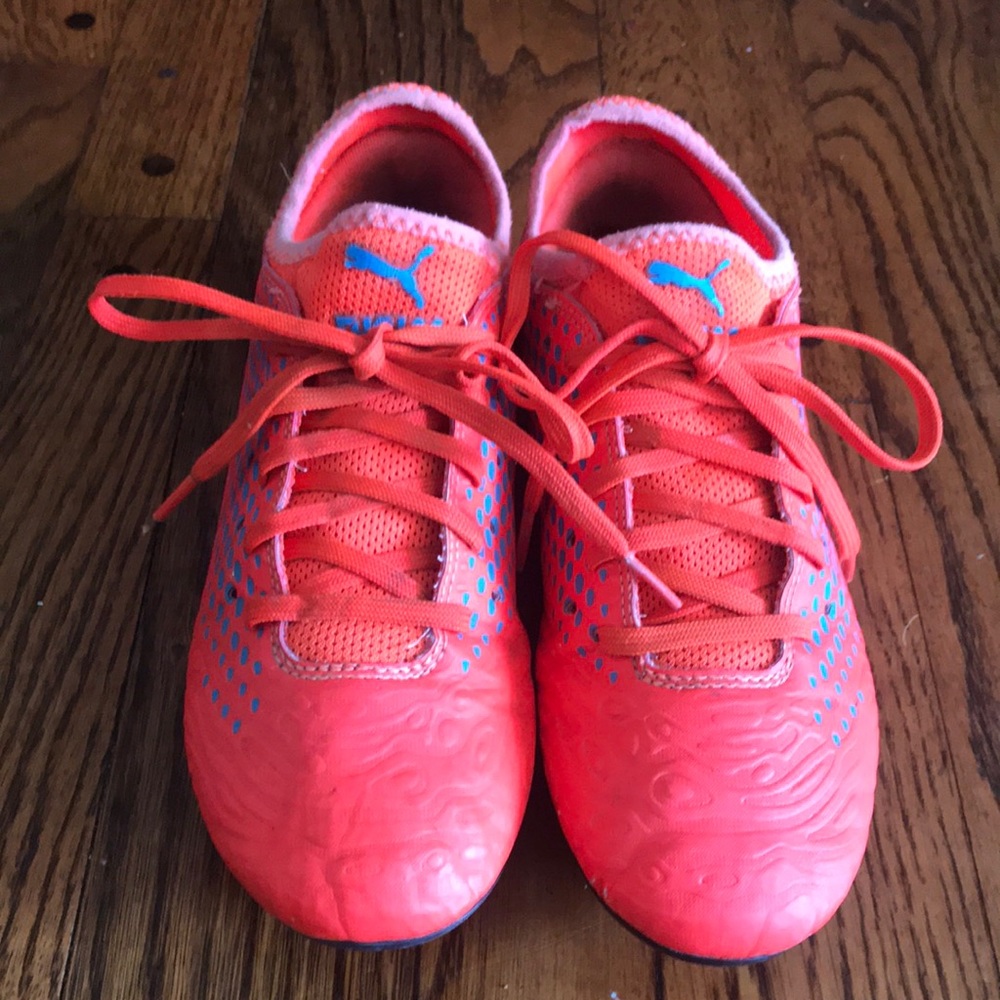 Orange puma soccer cleats
